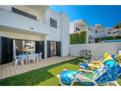 a white kitchen with white cabinets and a window at Apartment Rita - Sunny Way by Interhome in Albufeira