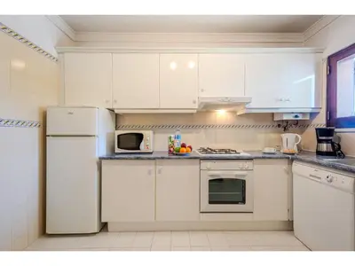 a living room with a couch and a table at Apartment Rita - Sunny Way by Interhome in Albufeira