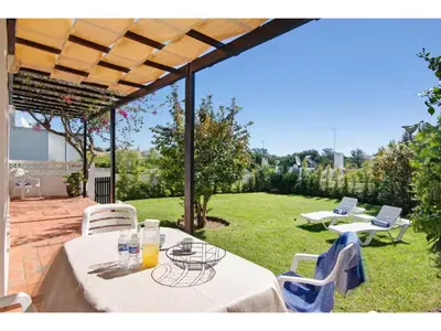 a patio with a table and chairs on a lawn at Holiday Home Casa Mila - Sunny Way by Interhome in Albufeira