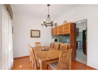 a dining room with a wooden table and chairs at Holiday Home Casa Mila - Sunny Way by Interhome in Albufeira
