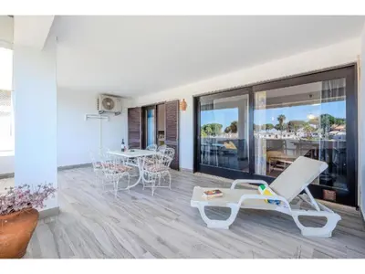 a bedroom with a bed and two windows at Apartment Ivone - Sunny Way by Interhome in Albufeira