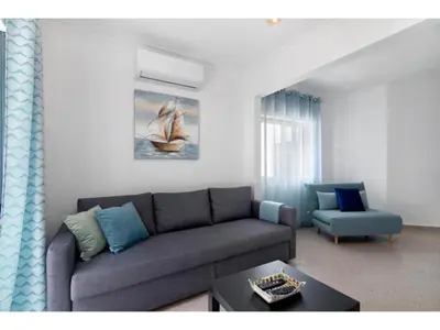 a living room with a couch and a chair at Apartment Jade-Sunny Way by Interhome in Albufeira