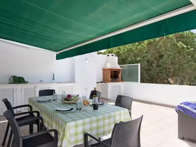 a patio with a couch and a table on a balcony at Apartment Kaya- Sunny Way by Interhome in Albufeira
