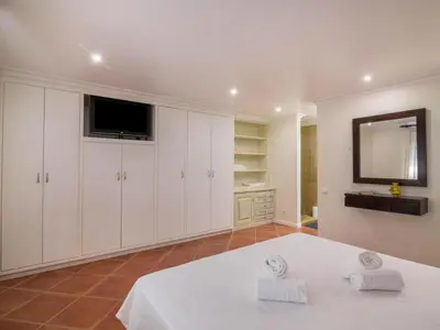 a large white room with a bed and a television at Apartment Malick - Sunny Way by Interhome in Albufeira