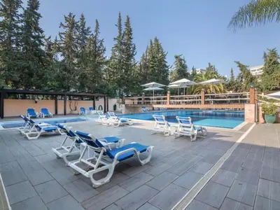 a swimming pool on a patio with a building at Apartment Malick - Sunny Way by Interhome in Albufeira