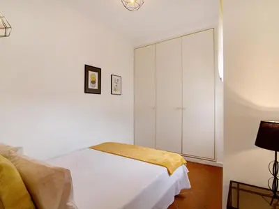 a bedroom with a bed with white sheets and a window at Apartment Medusa - Sunny Way by Interhome in Albufeira