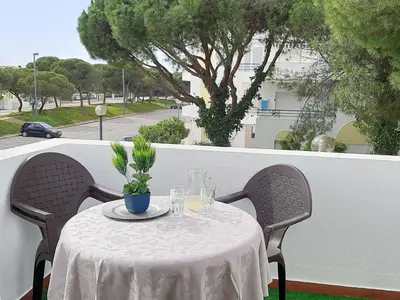 a table on a balcony with a view of a street at Apartment Medusa - Sunny Way by Interhome in Albufeira