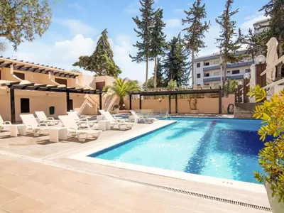 a swimming pool with lounge chairs and a building at Villa Amélia - Sunny Way by Interhome in Albufeira