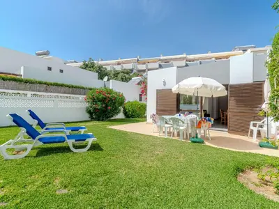 a kitchen and dining room with a table and chairs at Villa Amélia - Sunny Way by Interhome in Albufeira