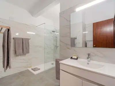a bathroom with a toilet and a glass shower at Villa Amélia - Sunny Way by Interhome in Albufeira