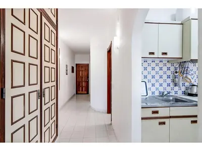 a kitchen with a door leading to a hallway at Apartment Anamar - Sunny Way by Interhome in Albufeira