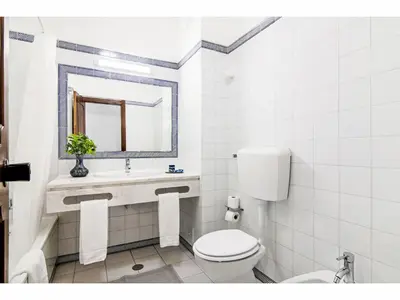 a bathroom with a toilet and a sink and a mirror at Apartment Anamar - Sunny Way by Interhome in Albufeira