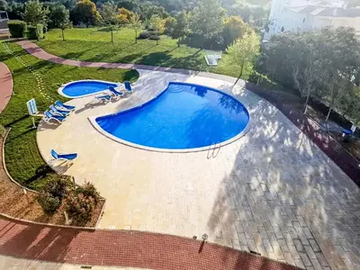 an overhead view of a large swimming pool with lounge chairs at Apartment Loft 39 - Sunny Way by Interhome in Albufeira