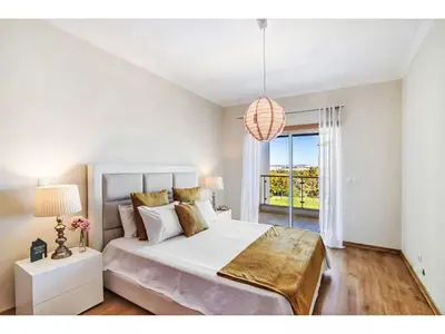 a white bedroom with a large bed and a window at Apartment Loft 39 - Sunny Way by Interhome in Albufeira
