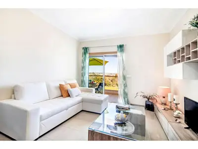 a living room with a white couch and a glass table at Apartment Loft 39 - Sunny Way by Interhome in Albufeira