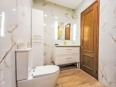 a white bathroom with a toilet and a sink at Apartment Manelito House - Sunny Way by Interhome in Albufeira