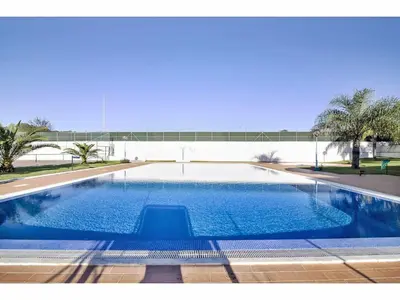 a large swimming pool with blue water at Apartment Manelito House - Sunny Way by Interhome in Albufeira