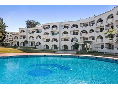 a swimming pool in front of a building at Apartment Max Tropical - Sunny Way by Interhome in Albufeira