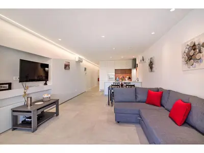 a living room with a blue couch and a table at Apartment Max Tropical - Sunny Way by Interhome in Albufeira