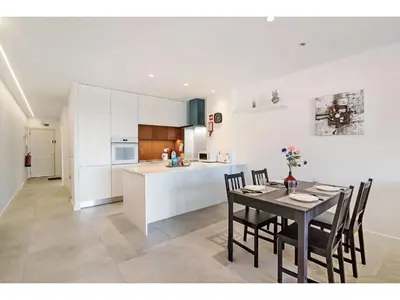 a kitchen and dining room with a table and chairs at Apartment Max Tropical - Sunny Way by Interhome in Albufeira
