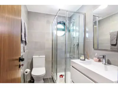 a bathroom with a shower and a toilet and a sink at Apartment W Marina - Sunny Way by Interhome in Albufeira