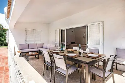 a yard with lounge chairs and a swimming pool at 4 Beds, Golf Views, optional pool heating in Vilamoura