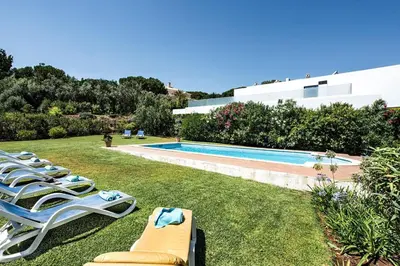 a patio with a couch and a table at 4 Beds, Golf Views, optional pool heating in Vilamoura