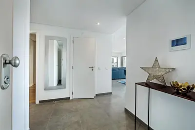 a living room with white walls and a star on a table at Lovely Modern Apartment With Pool in Albufeira