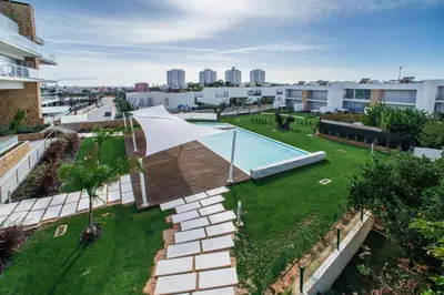 an aerial view of a garden with a swimming pool at Lovely Modern Apartment With Pool in Albufeira