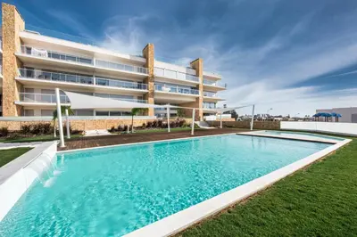 a swimming pool in front of a building at Lovely Modern Apartment With Pool in Albufeira