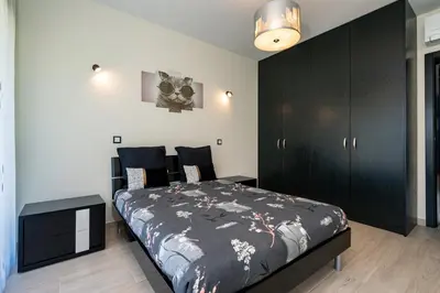 a bedroom with a bed and a black cabinet at Vitoria 7th hole by SAPvillas in Vilamoura