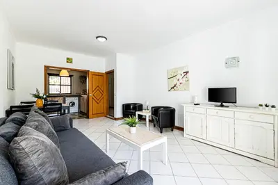 a living room with a couch and a table at Ground floor with direct access to swimming pool in Albufeira