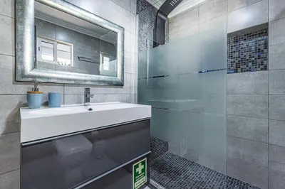 a bathroom with a sink and a mirror at Quiet & Sea in Albufeira
