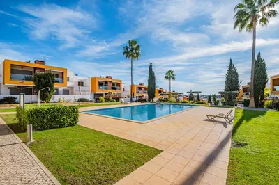 a villa with a swimming pool and palm trees at Vitismar Praia Algarve in Guia