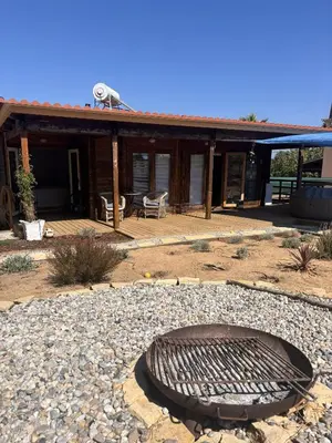 a fire pit in front of a house at Casa na Colina in Almancil