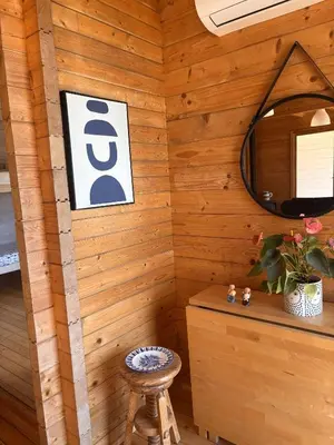 a room with a wooden wall with a mirror and a stool at Casa na Colina in Almancil