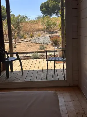 a porch with two chairs and a table at Casa na Colina in Almancil