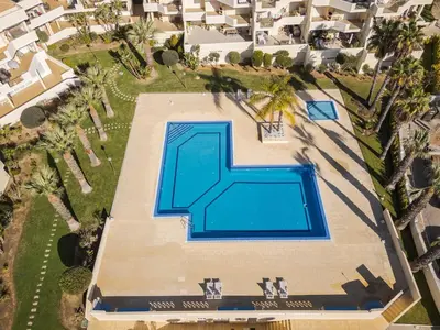an overhead view of a swimming pool in a resort at Palm Breeze Retreat in Albufeira w Pool and Balcony by Lisbeyond in Albufeira