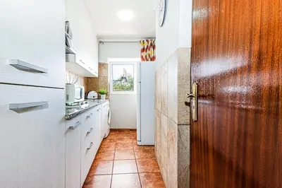 a hotel room with two beds and a tv at 5-minute walk to Aveiros Beach in Albufeira