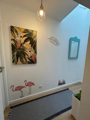 a room with two pink flamingos on the wall at Dolce Faro Niente Guest House in Faro
