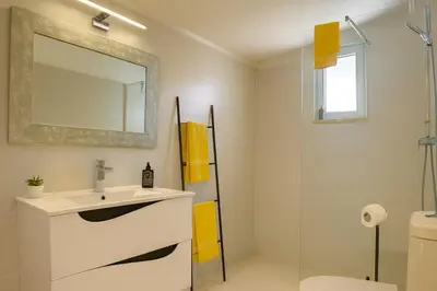a white bathroom with a sink and a mirror at Villa Mar by Sunny Deluxe in Albufeira
