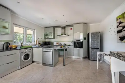 a kitchen with a sink and a dishwasher at Lovely Vacation Villa In Loulé in Loulé