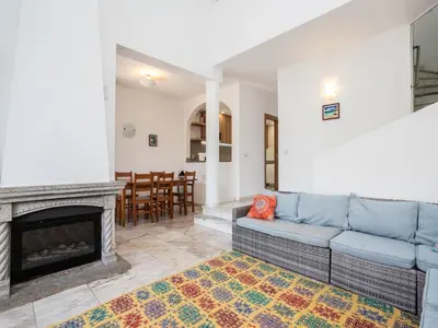 a living room with a couch and a fireplace at Akivillas Albufeira Now in Olhos de Água