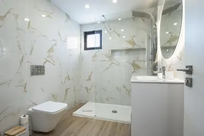 a bathroom with a toilet and a sink and a mirror at Marina Búzios I & II - Vilamoura Marina by HD in Vilamoura