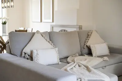 a living room with a gray couch with pillows at Marina Búzios I & II - Vilamoura Marina by HD in Vilamoura