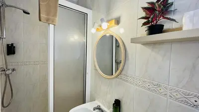 a bathroom with a shower and a sink and a mirror at Jardim da Oura by Check-in, Portugal in Albufeira