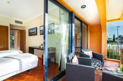 a hotel room with a bed and a balcony at F5 Vila Sol G Pool & Golf in Vilamoura in Quarteira