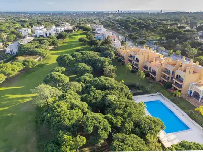 an aerial view of a resort with a swimming pool and trees at F5 Vila Sol G Pool & Golf in Vilamoura in Quarteira
