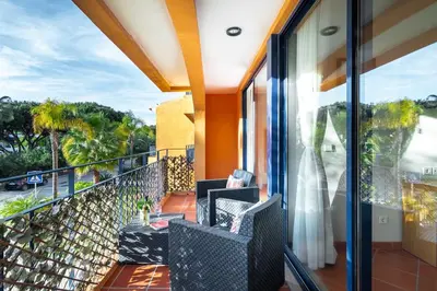 a balcony with two chairs and a view of the ocean at F5 Vila Sol G Pool & Golf in Vilamoura in Quarteira