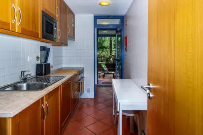 a kitchen with a sink and a counter top at F5 Vila Sol AI Pool & Golf in Vilamoura in Quarteira